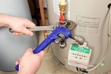 One of our plumbers repairing a water heater.