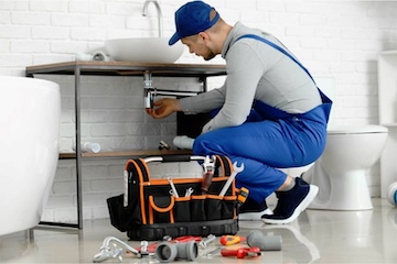 Our plumber fixing a bathroom sink.